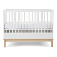 Obaby Astrid MINI Cot Bed - White - showing the mini cot with its mattress base at the middle level